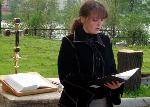 Student Natasha Kolesnik reads at the service