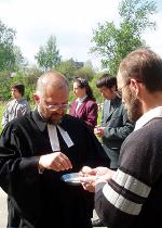 Dr. Reuter distributes the elements of Holy Communion to student Andrei Kuznetsov